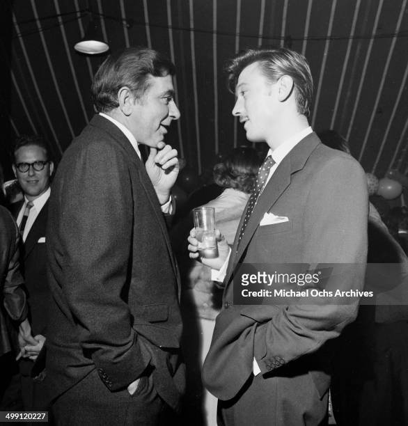 Actor Laurence Harvey with Robert Newton attend a Mike Todd party in Los Angeles, California.