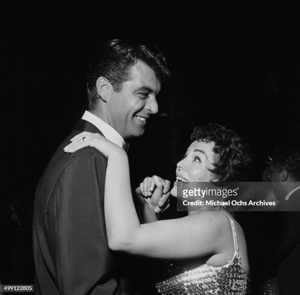 Actor Rory Calhoun dances with actress Lita Baron during a premiere party for "Trapeze" in Los Angeles, California.