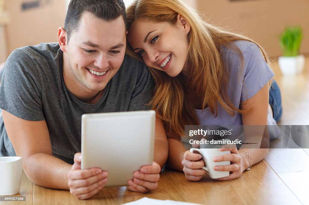 Young couple shopping online for their new home