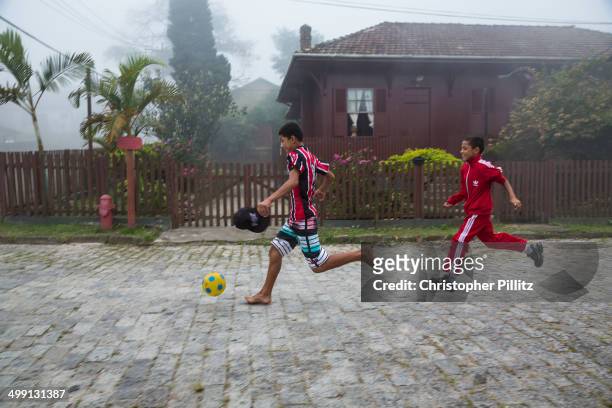 In the former British railway village of Paranapiacaba, it is said that football was introduced to Brazil by Charles Miller. Here boys play football...