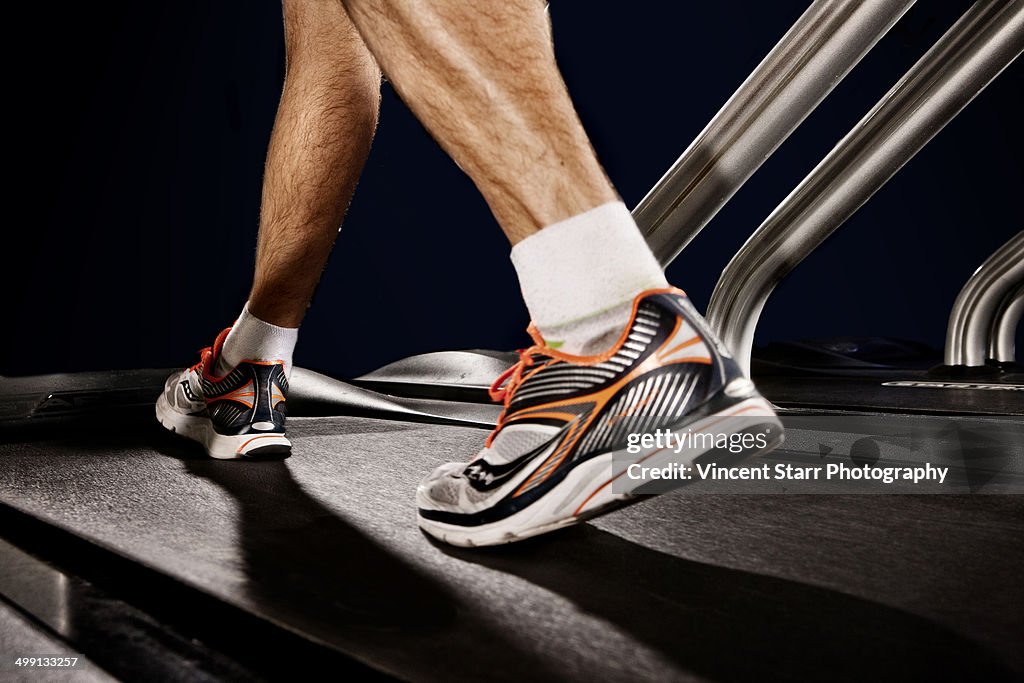 Close up of male legs running on gym treadmill in altitude centre