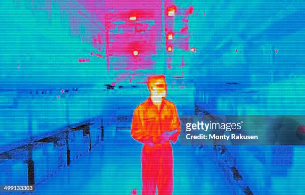 infra red heat image of warehouse worker in factory - infrared stockfoto's en -beelden