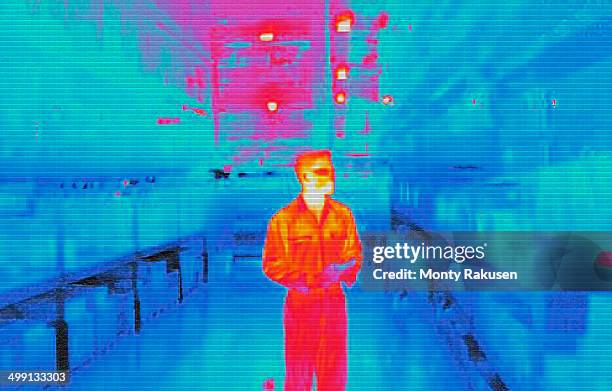 infra red heat image of warehouse worker in factory - thermal image stock pictures, royalty-free photos & images