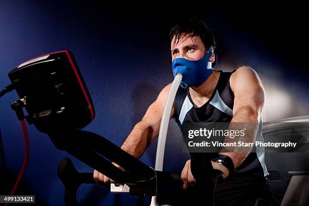 mid adult man in face mask on gym exercise cycle in altitude centre - science measurement stock pictures, royalty-free photos & images