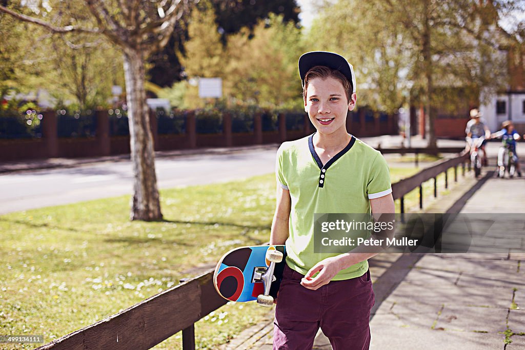 Portrait of boy holding skateboard