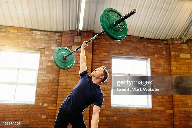 man lifting barbell with one hand - hand weight ストックフォトと画像