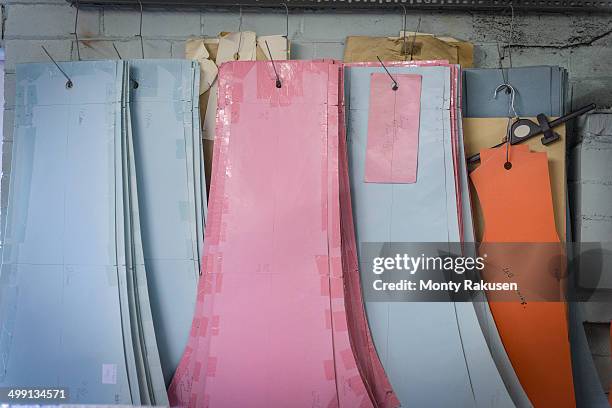 patterns hanging in clothing factory - schnittmuster stock-fotos und bilder