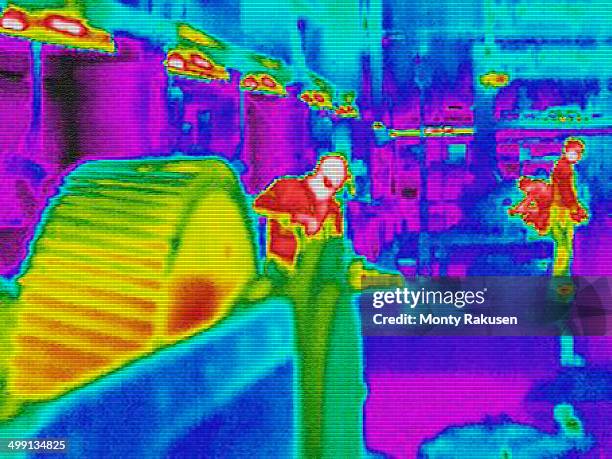 infra red heat image of workers and heat loss at work station in factory - thermal image stock pictures, royalty-free photos & images