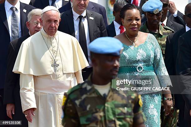 Pope Francis walks after being welcomed by interim leader of the Central African Republic, Catherine Samba Panza, at the State House in Bangui, on...