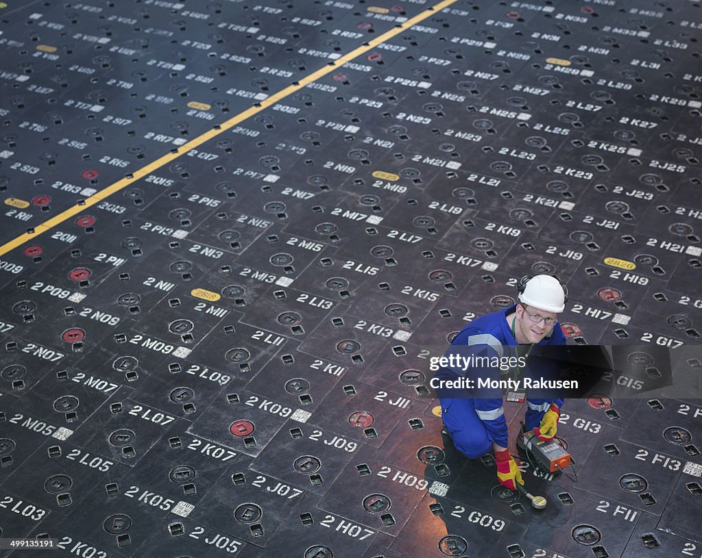 Engineer using sensors on pile cap in nuclear power station, portrait