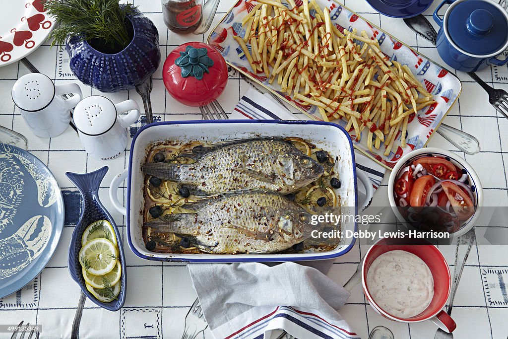 Fresh fish with chips and condiments