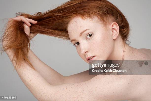 portrait of young woman, pulling hair - pulling hair stock pictures, royalty-free photos & images