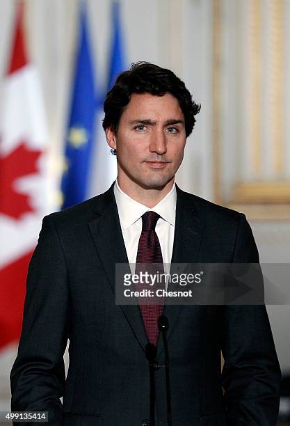 Canadian Prime minister, Justin Trudeau makes a statement during a press conference next to French President Francois Hollande at the Elysee...
