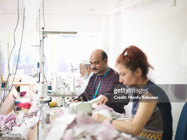 garment workers in clothing factory - textile factory stock pictures, royalty-free photos & images