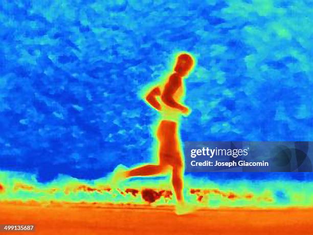 thermal photograph of young male athlete running. the image shows the heat of the muscles - thermal imaging imagens e fotografias de stock
