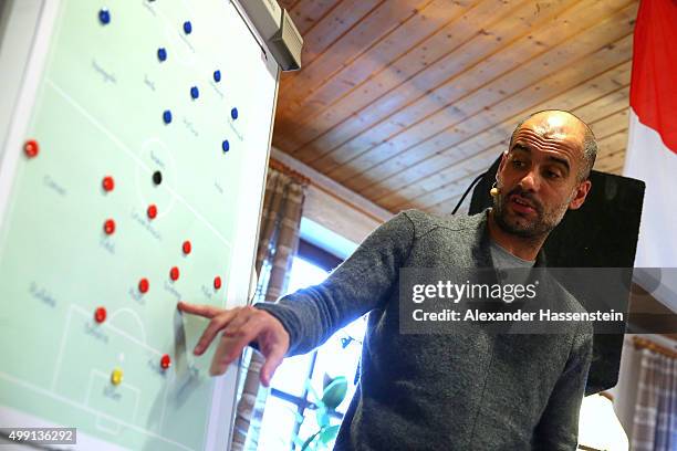 Joseph Guardiola, head coach of FC Bayern Muenchen shows tactical moves on a tactics board during his visit to the FC Bayern Muenchen supporter club...