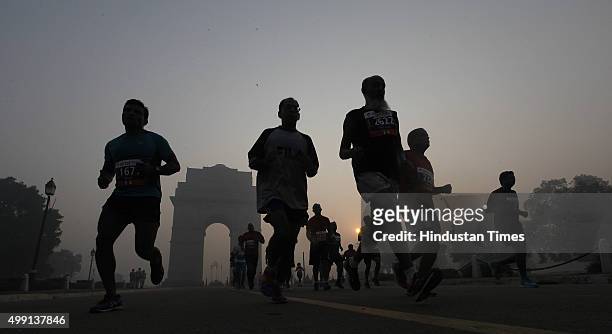 Runners take part in Airtel Delhi Half Marathon 2015 at Rajpath in the foggy weather on November 29, 2015 in New Delhi, India. This year Delhi half...