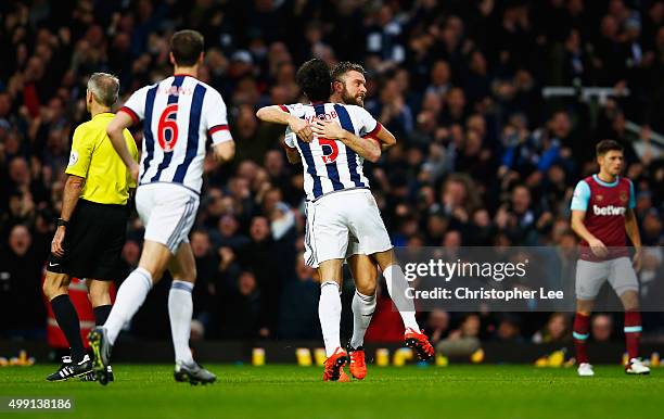 Rickie Lambert of West Bromwich Albion celebrates with Claudio Yacob as his shot deflects off of Winston Reid of West Ham United for their equalising...