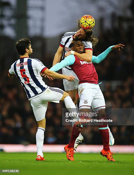 Jonas Olsson of West Bromwich Albion climbs over Diafra Sakho of West Ham United as Claudio Yacob of West Bromwich Albion looks on during the...
