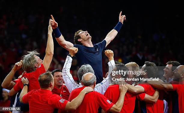 Andy Murray of Great Britain celebrates with his team-mates after winning his match to win the Davis Cup for Great Britain during day three of the...