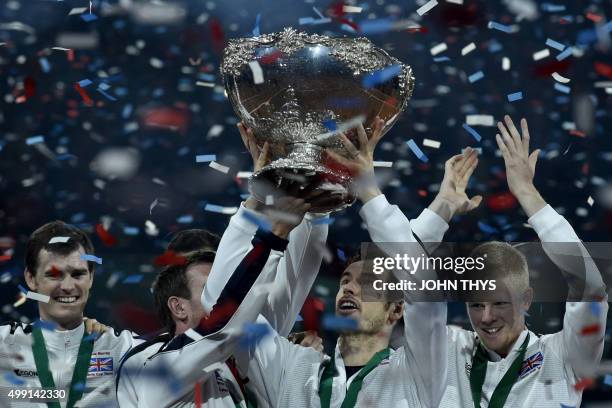 Britain's Andy Murray holds up the trophy next to Britain's Jamie Murray and Britain's Kyle Edmund as they celebrate after winning the Davis Cup...