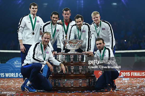 Jamie Murray, Dom Inglot, James Ward, Leon Smith, Andy Murray, Kyle Edmund and Dan Evans of Great Britain pose with the Davis Cup following victory...