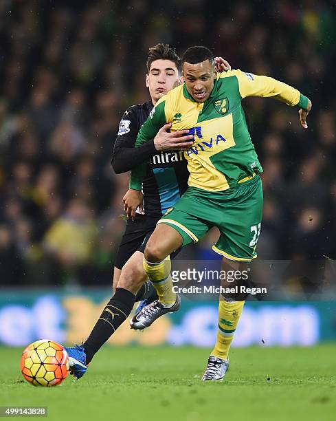 Martin Olsson of Norwich City tussles with Hector Bellerin of Arsenal during the Barclays Premier League match between Norwich City and Arsenal at...
