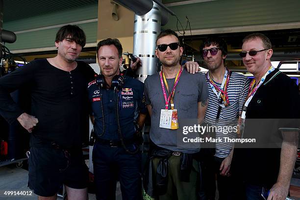 Infiniti Red Bull Racing Team Principal Christian Horner poses with Alex James, Damon Albarn, Graham Coxon and Dave Rowntree of Blur outside the...