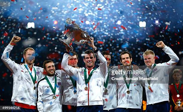 Great Britain Captain Leon Smith lifts the trophy with his players following their victory during day three of the Davis Cup Final match between...