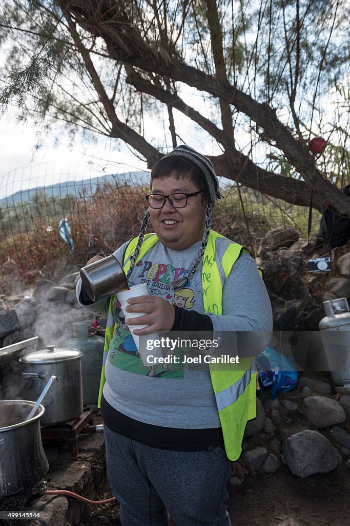 Volunteer pouring tea for refugees on Lesbos, Greece