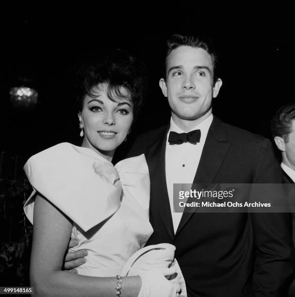 Actor Warren Beatty and actress Joan Collins attend a party in Los Angeles, California.