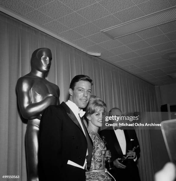 Actor Richard Chamberlain poses with an actress at the Academy Awards in Los Angeles, California.