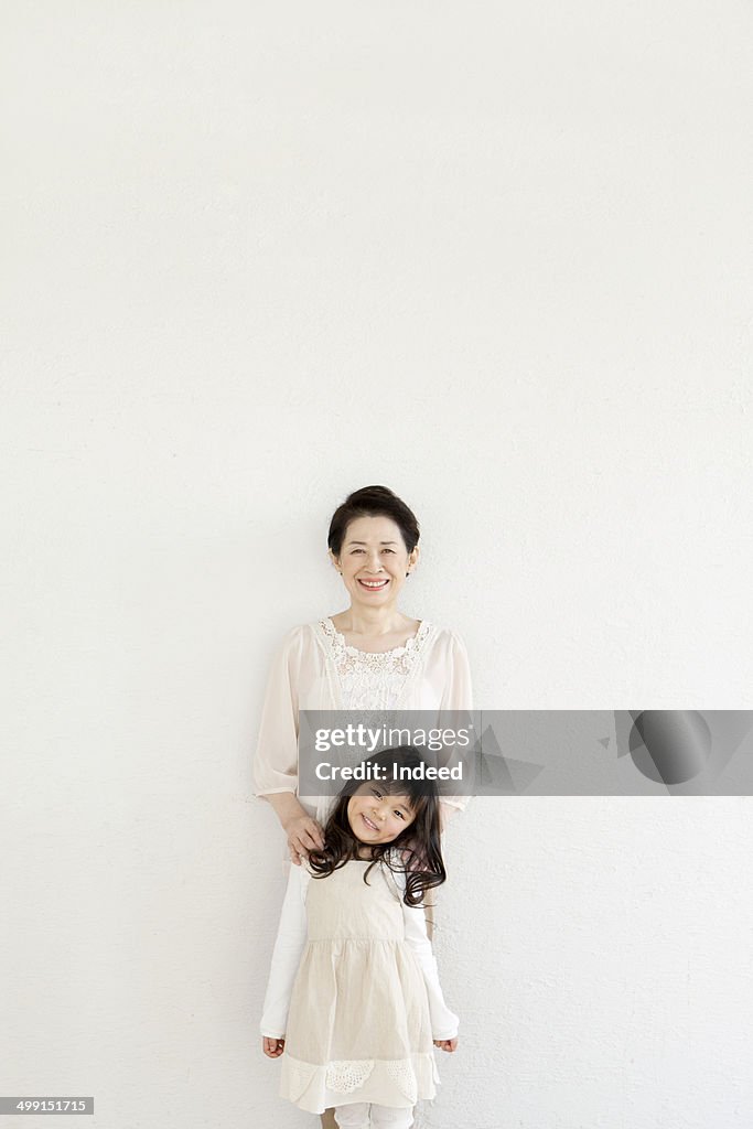 60th generation woman standing with her grand daughter