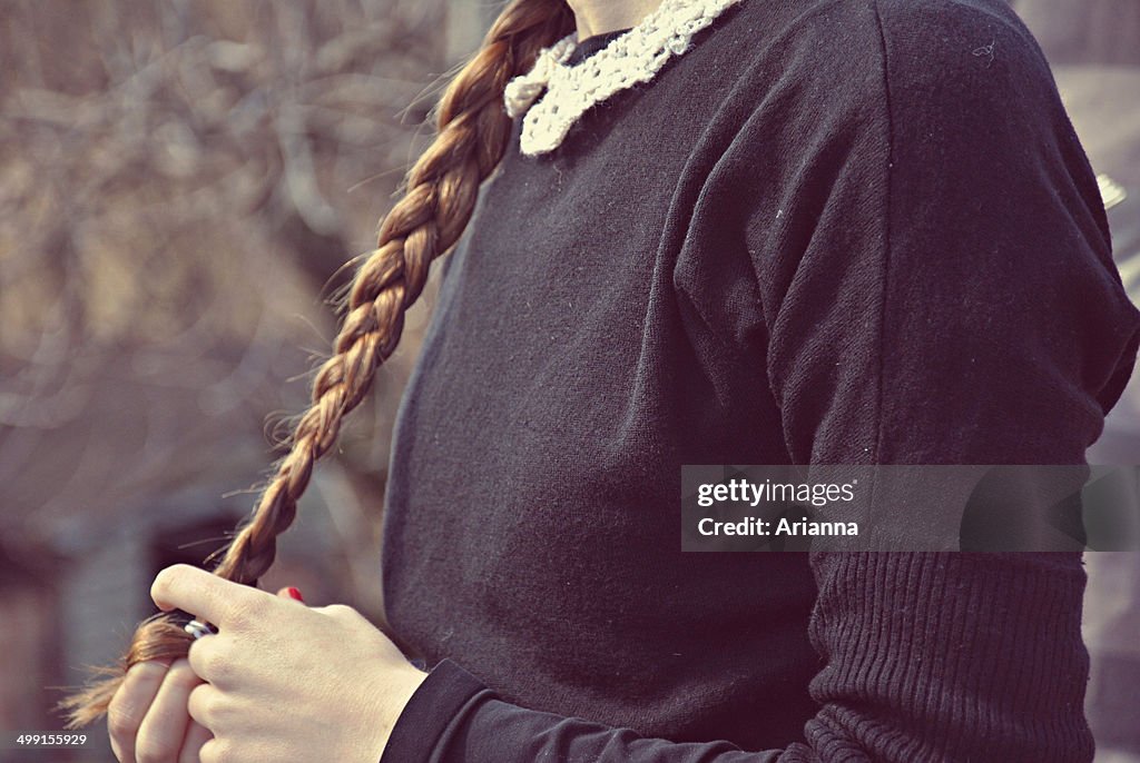Girl playing with her braid