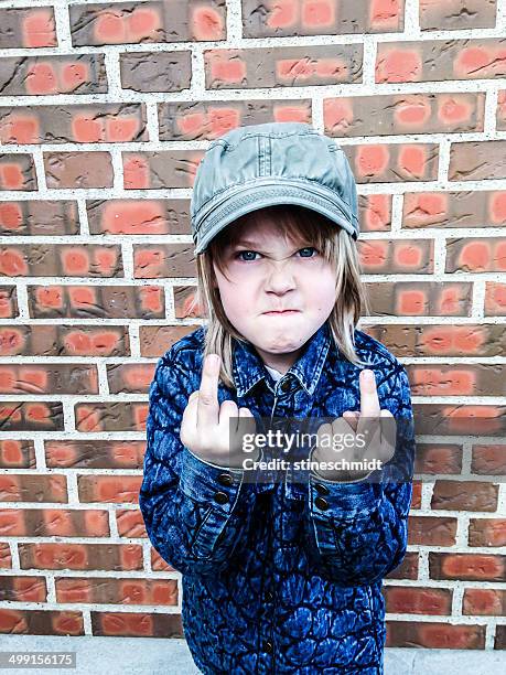 boy making obscene gesture - doigt dhonneur stockfoto's en -beelden