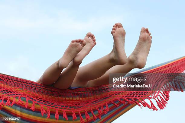 children's feet in hammock - jj girls fotografías e imágenes de stock