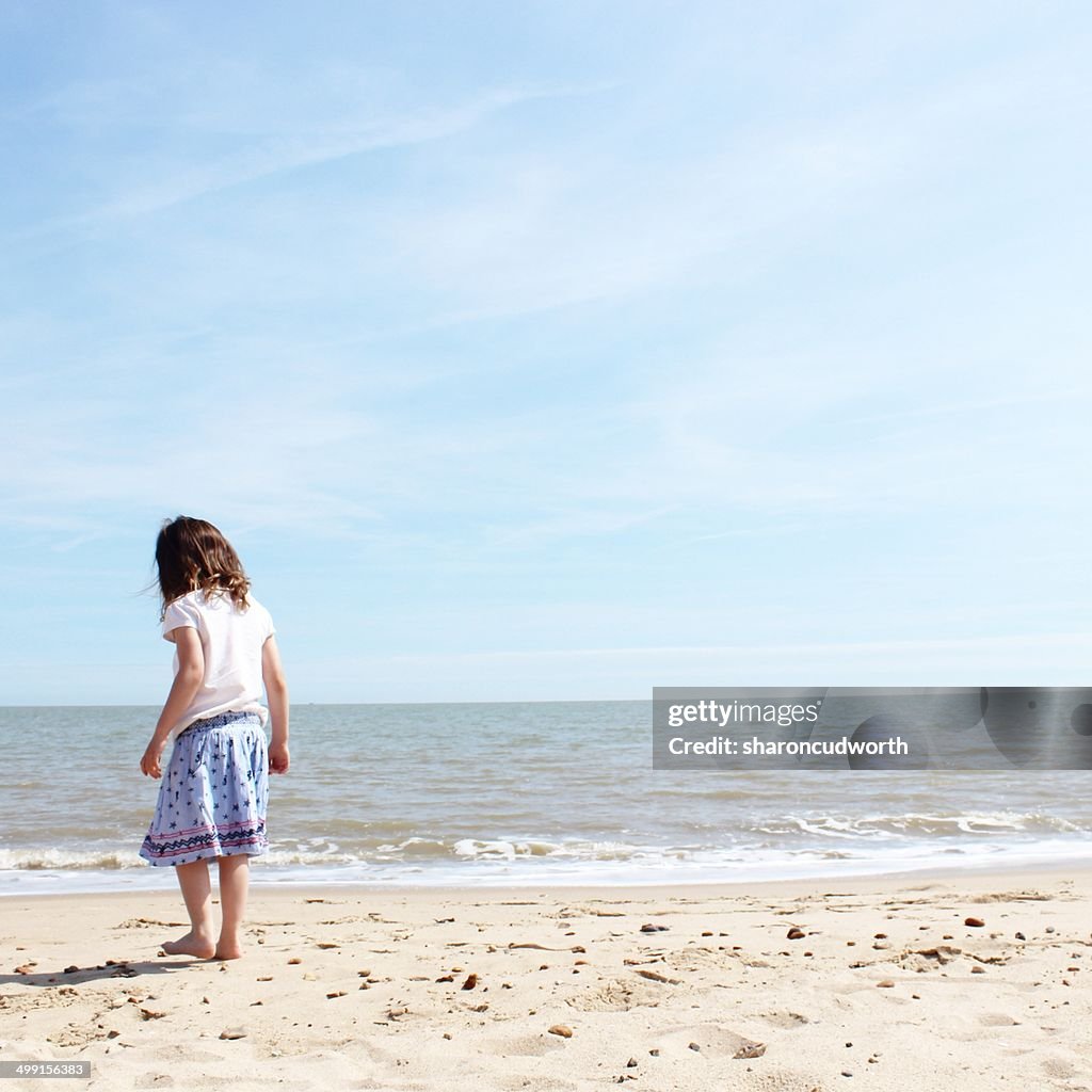 Rear view of girl standing on beach