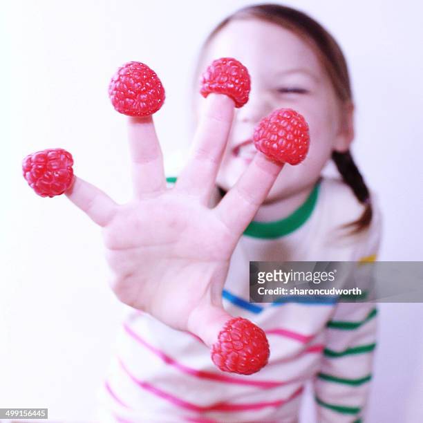 girl with raspberries on her fingers - 5 funny stock pictures, royalty-free photos & images