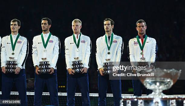 Jamie Murray, James Ward, Kyle Edmund, Andy Murray and Leon Smith of Great Britain celebrate with their trophies following victory on day three of...