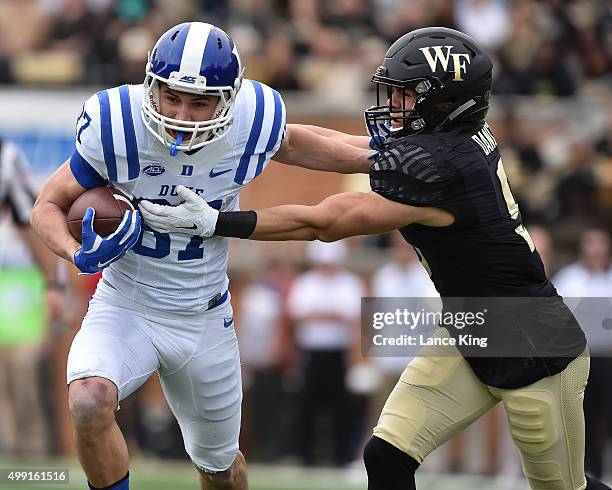 Max McCaffrey of the Duke Blue Devils runs with the ball against Zach Dancel of the Wake Forest Demon Deacons at BB&T Field on November 28, 2015 in...