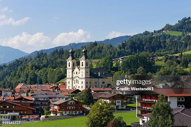 austria, tyrol, kitzbuehel alps, brixen valley, hopfgarten with parisch church - hopfgarten stock pictures, royalty-free photos & images