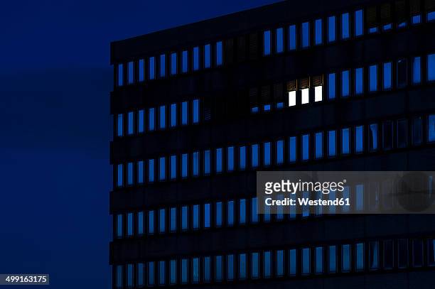 germany, dusseldorf, lighted windows in office building - facade works stock pictures, royalty-free photos & images