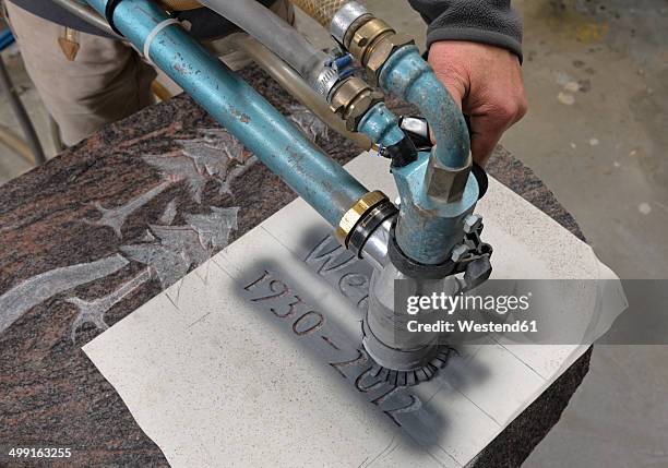 germany, stone mason manufacturing grave stone - sandblasting stockfoto's en -beelden