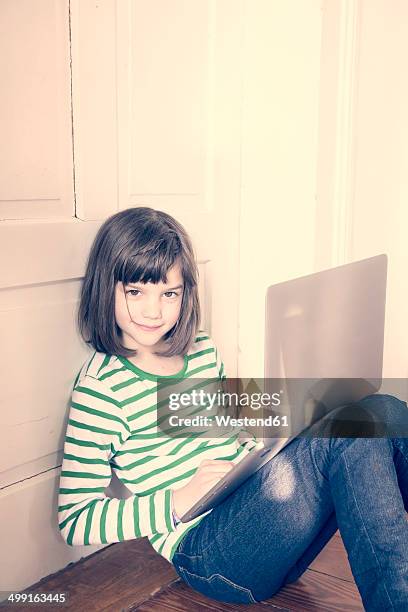portrait of little girl with laptop at home - girl sitting with legs open stock pictures, royalty-free photos & images