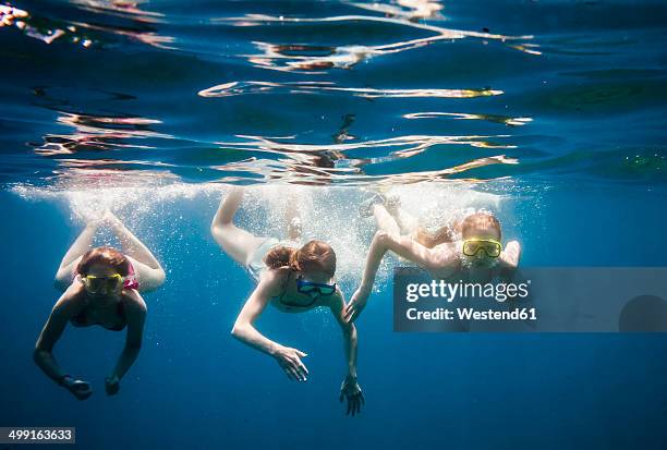 croatia, brac, sumartin, three girls under water - croatia girls stock-fotos und bilder