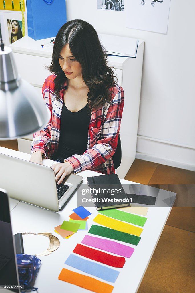 Female fashion bloggers working in her office, elevated view