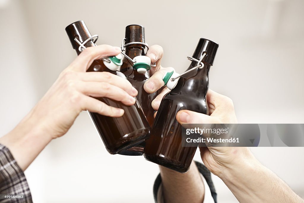Friends clinking beer bottles