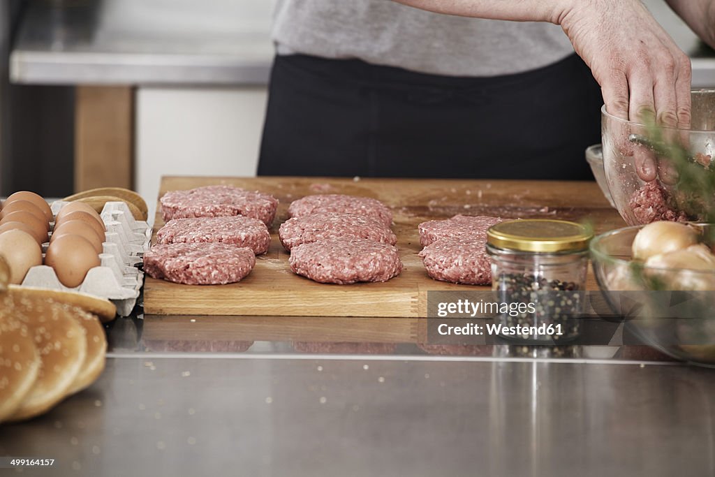 Man preparing meatballs in kitchen