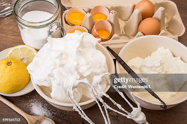 bowl of beaten egg white and other baking ingredients of meringues on wooden table - cartons of quark stock pictures, royalty-free photos & images