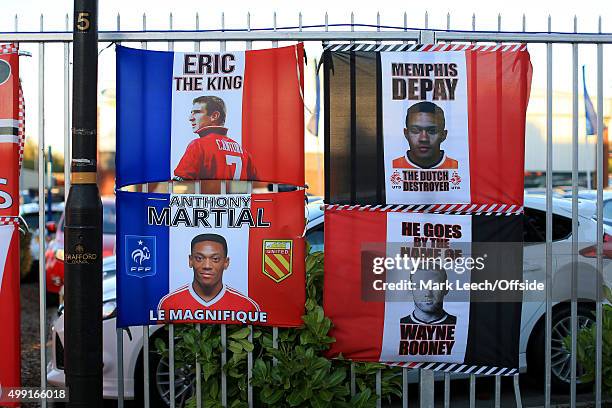 Souvenir flags bearing the faces of Eric Cantona, Anthony Martial, Memphis Depay and Wayne Rooney seen fixed to a fence prior to the UEFA Champions...